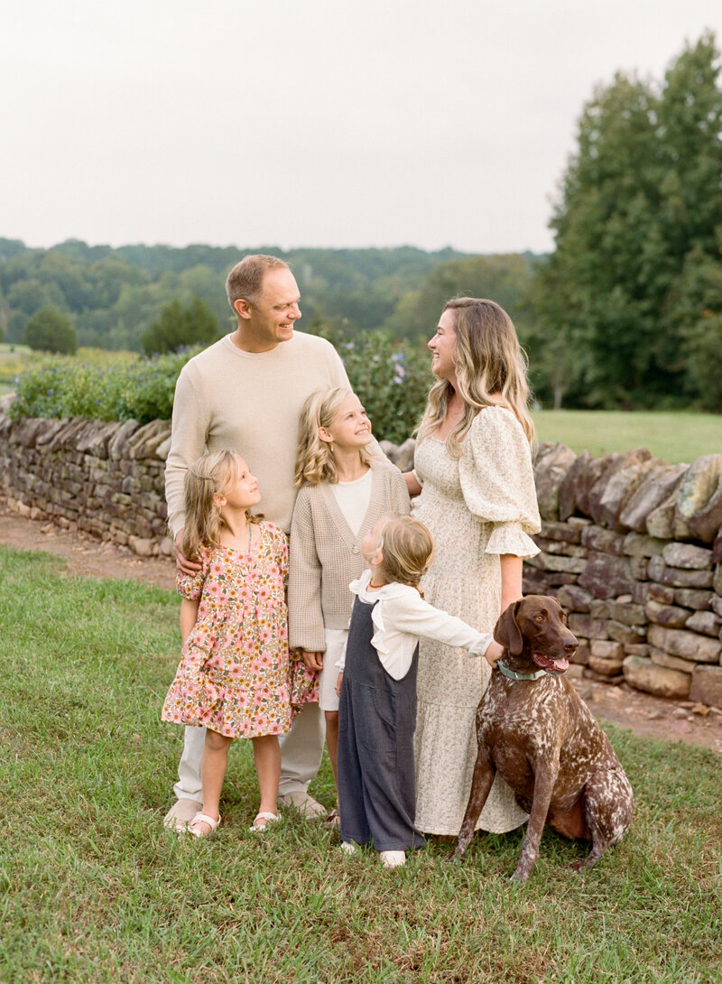 Image of Raleigh family photographer A.J. Dunlap Photography with her family and their gsp.