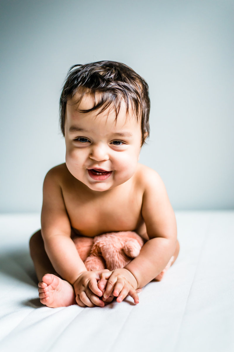 Sitting baby laughing