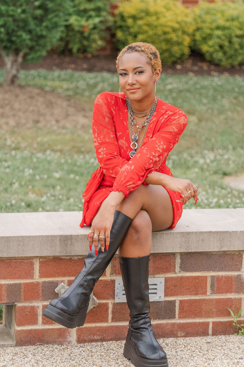 girl sitting outside her high school during senior photography in Nokesville, VA