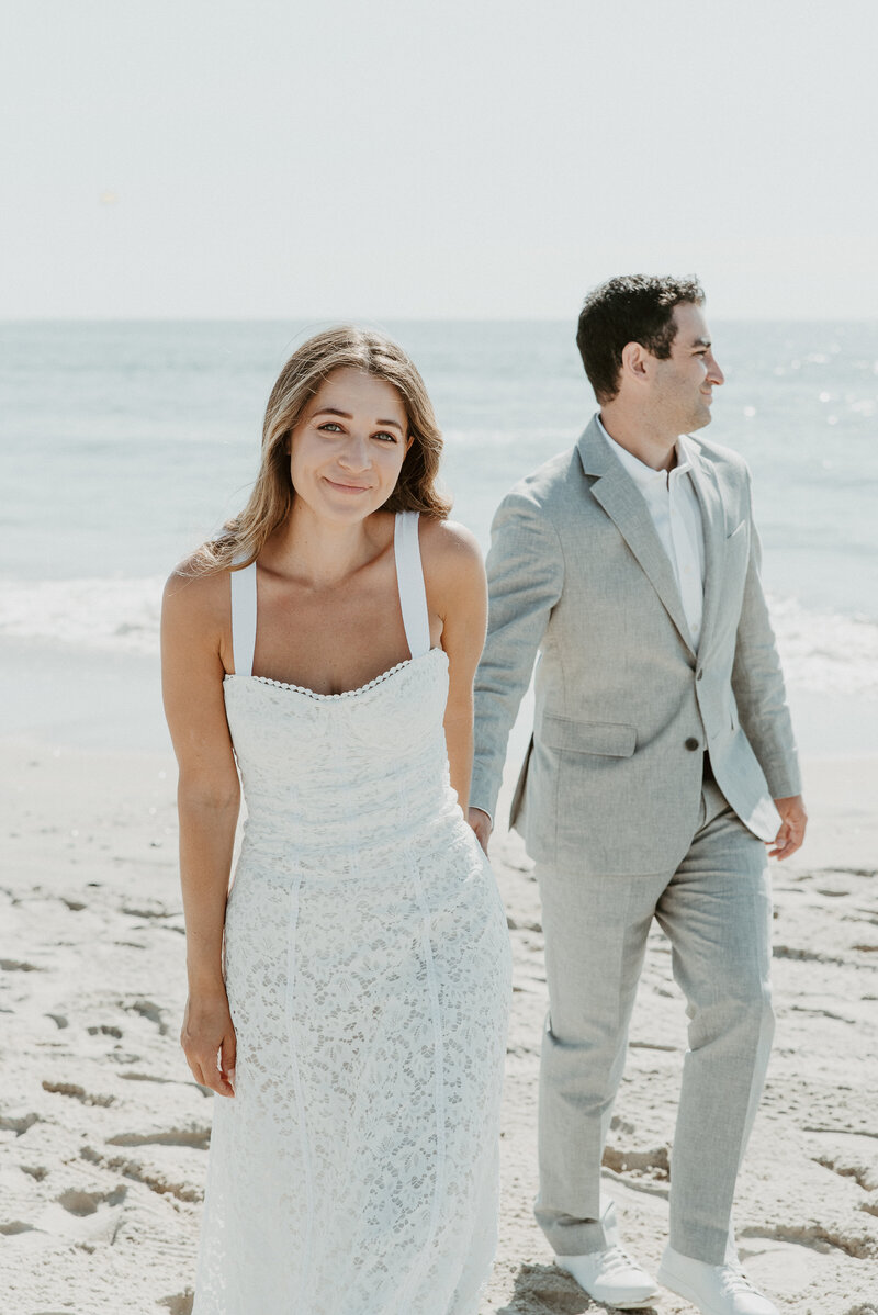 Bride and groom walking on beach at Carlsbad wedding