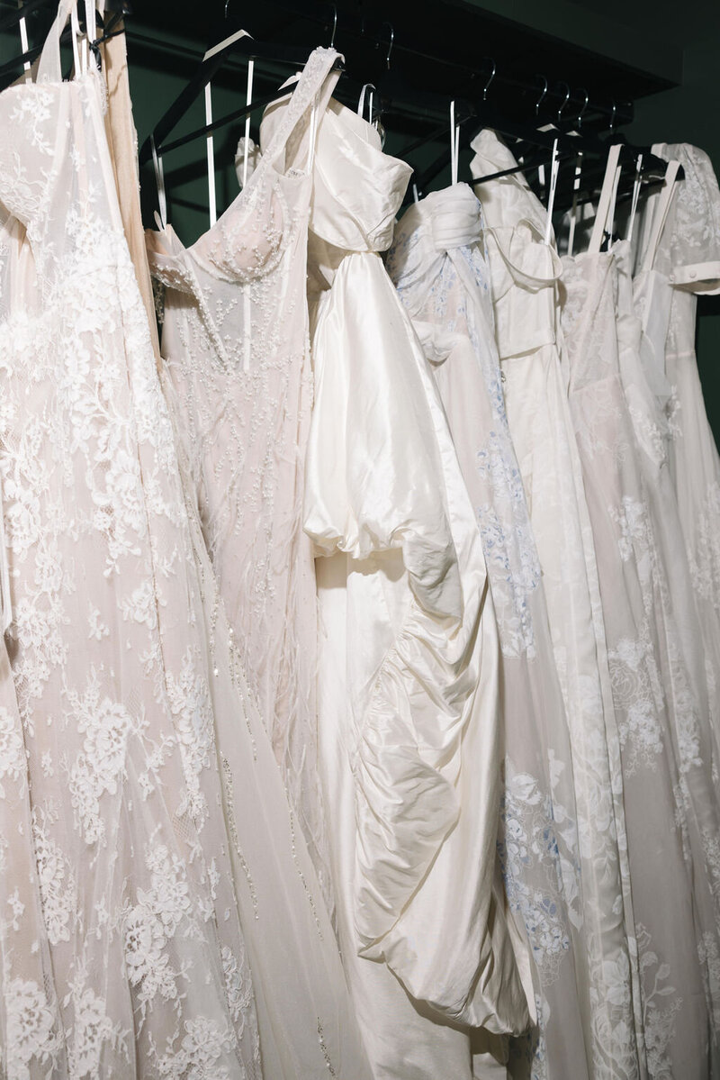 bride in high neck satin wedding dress next to building column