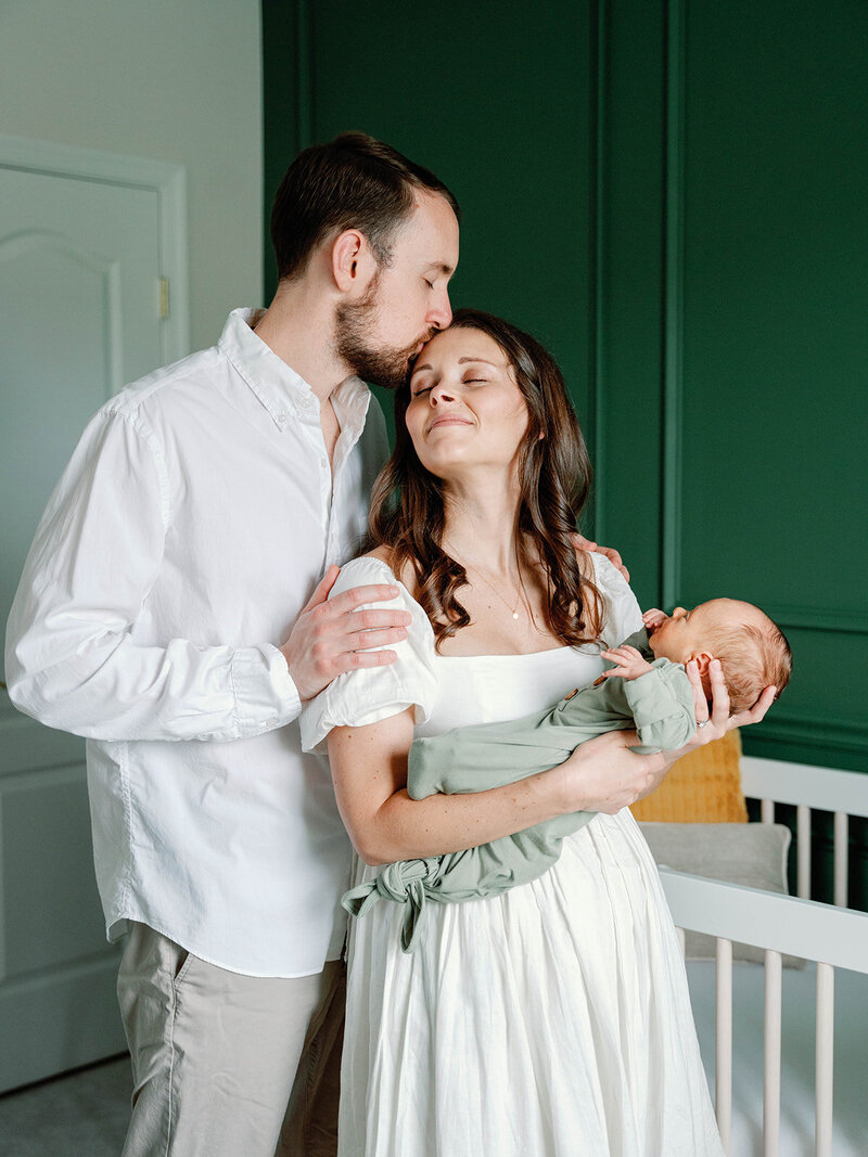 Couple in baby nursery for their at homes session