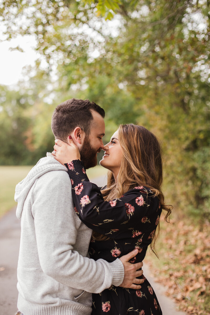 man and woman kissing during outdoor engagement session