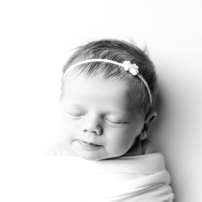 Softness and serenity shine in this gentle newborn smile.