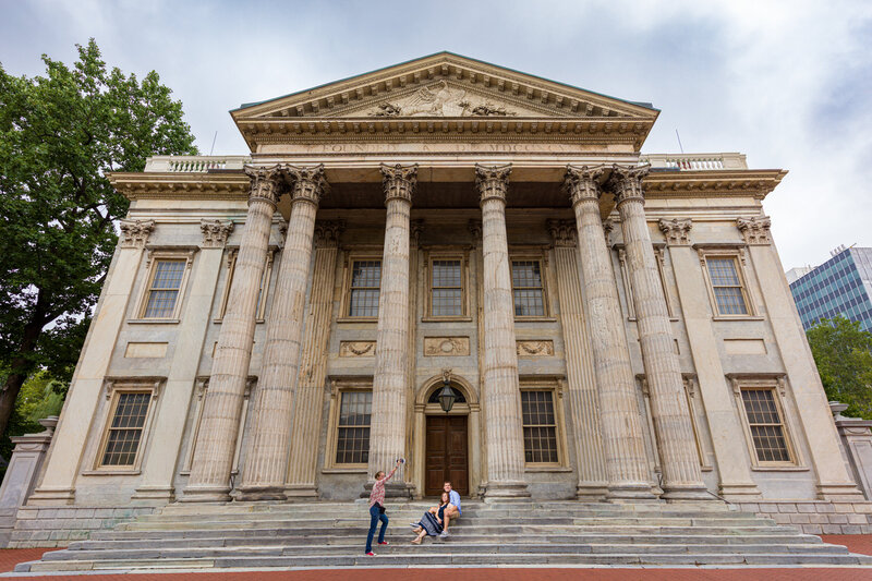 Jen Stitt at First Bank with a history-loving couple, capturing timeless and elegant engagement session moments in a location rich with historical significance.