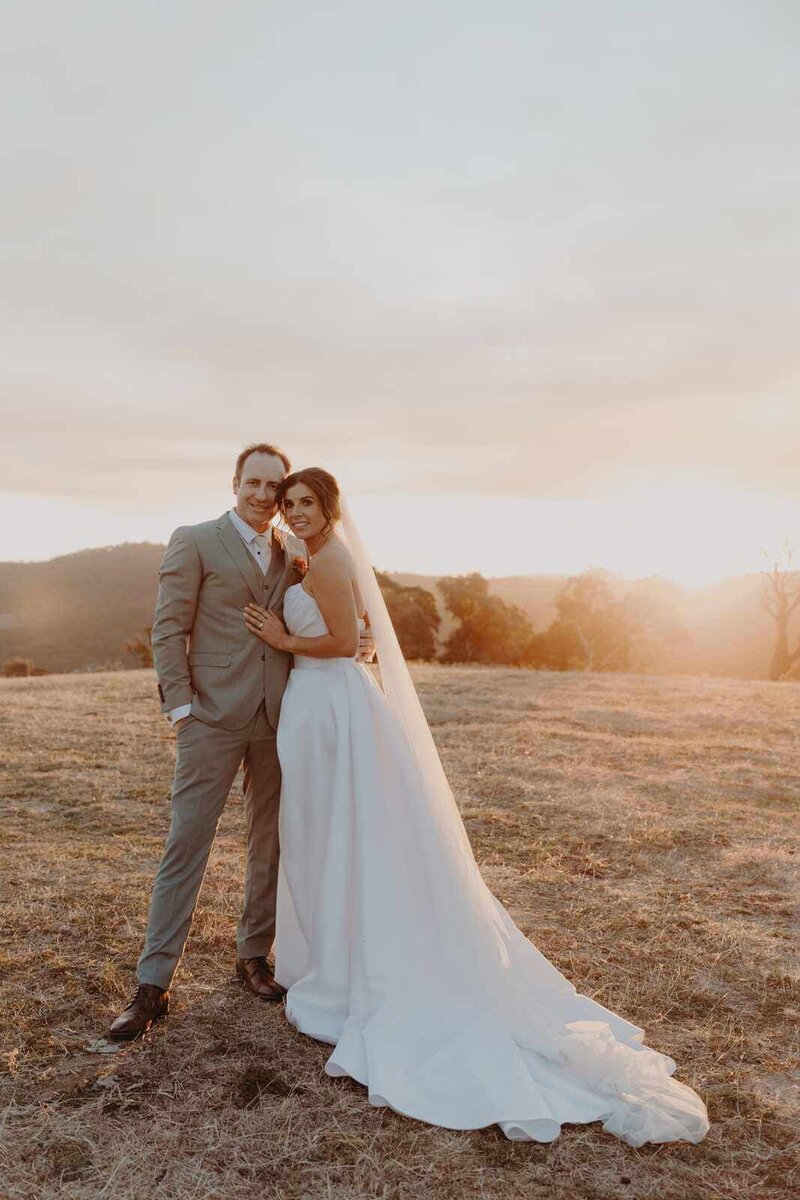 Bride and groom hugging each other.