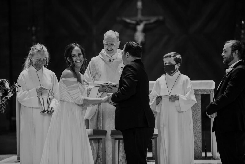 A couple standing up at the altar during their wedding