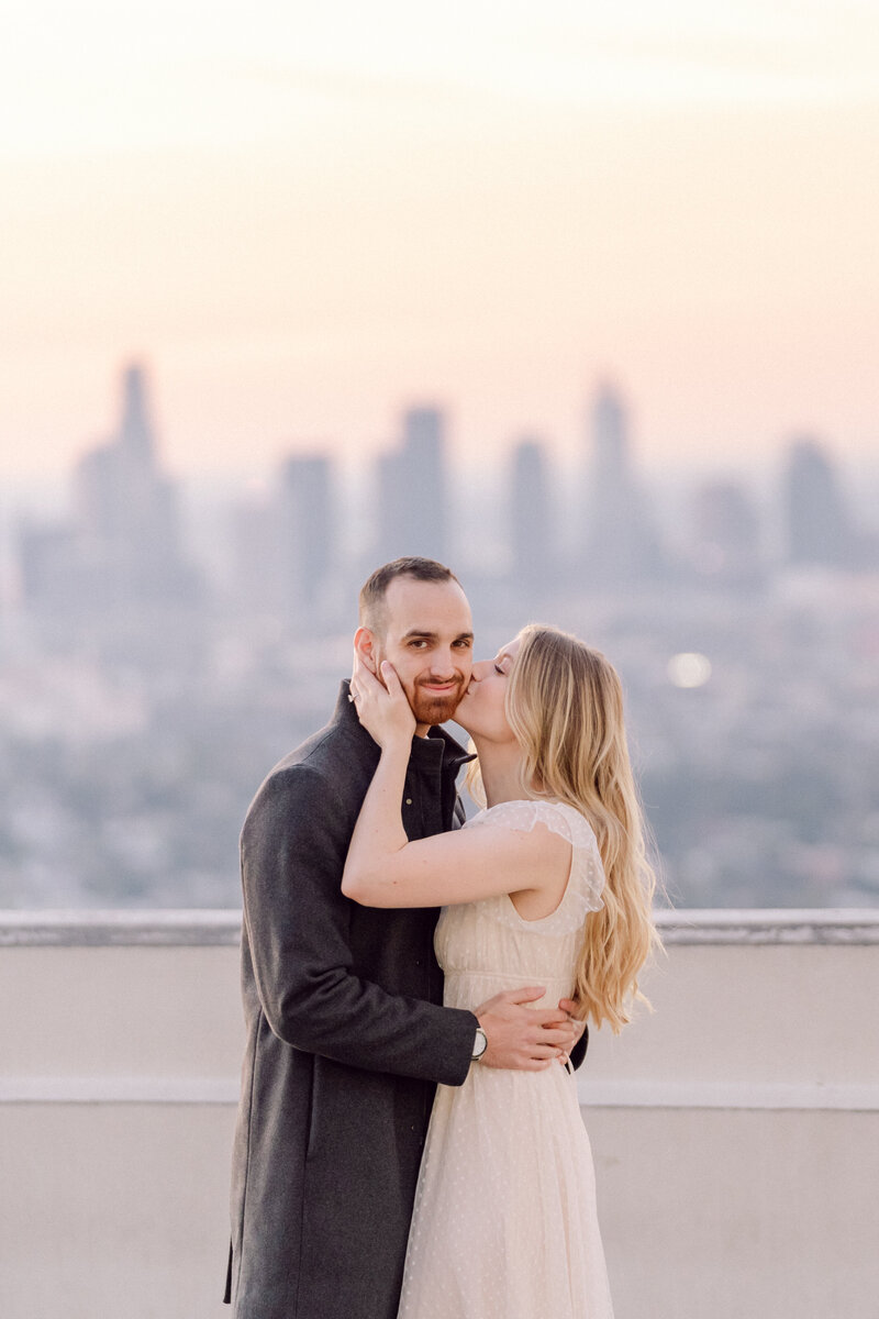 future bride and groom pose at the look out at sunrise at the griffith observatory in los angeles taken by los angeles wedding photographer magnolia west photography