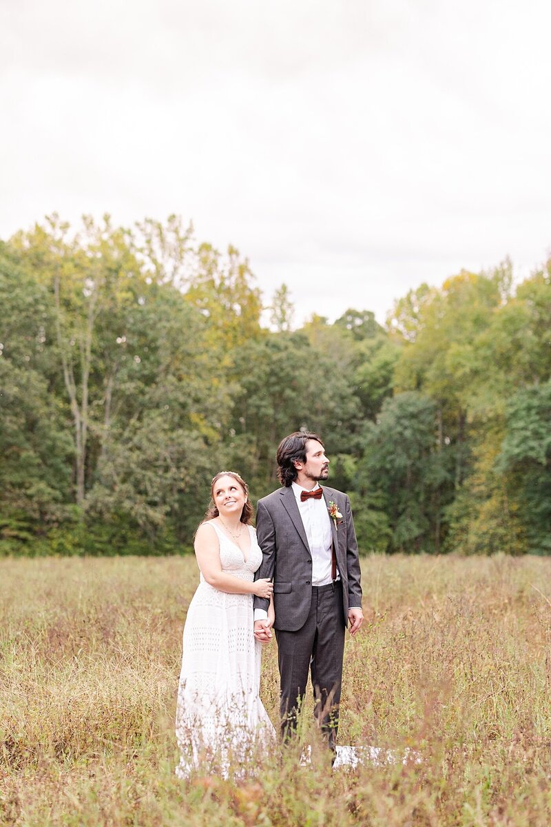Bride and groom standing in a field at Avonlea Farms in Richmond, Virginia.