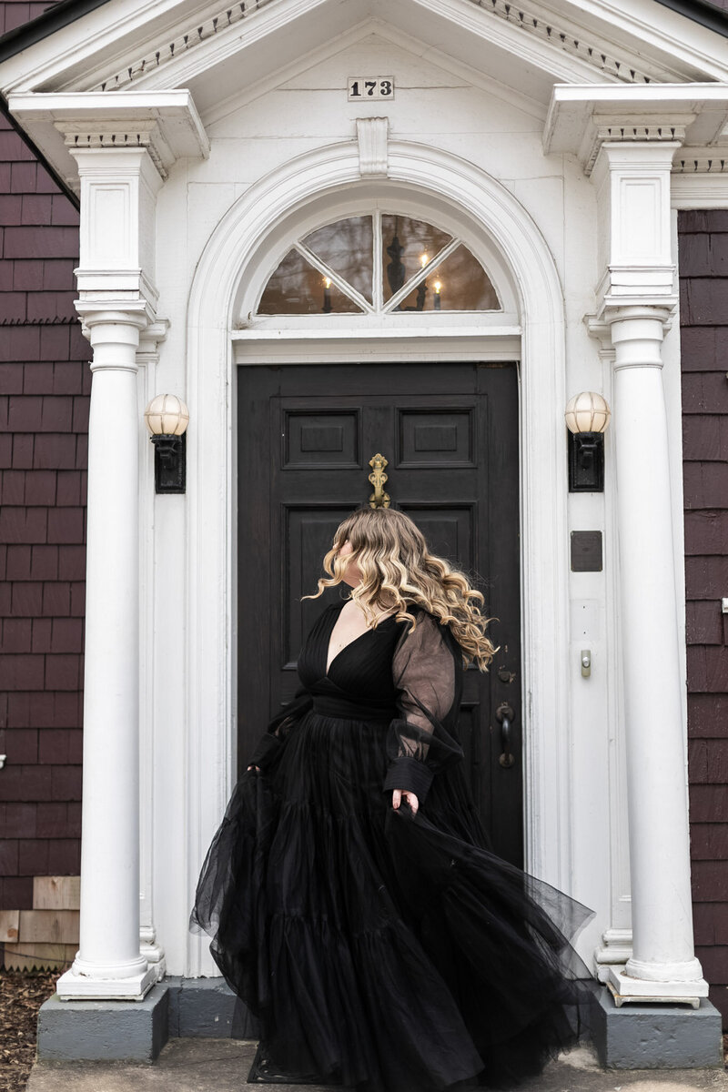 Portrait of a woman in a black gown symbolizing transformation — Ashleigh Henry helps high-capacity women soften into their most sacred selves.
