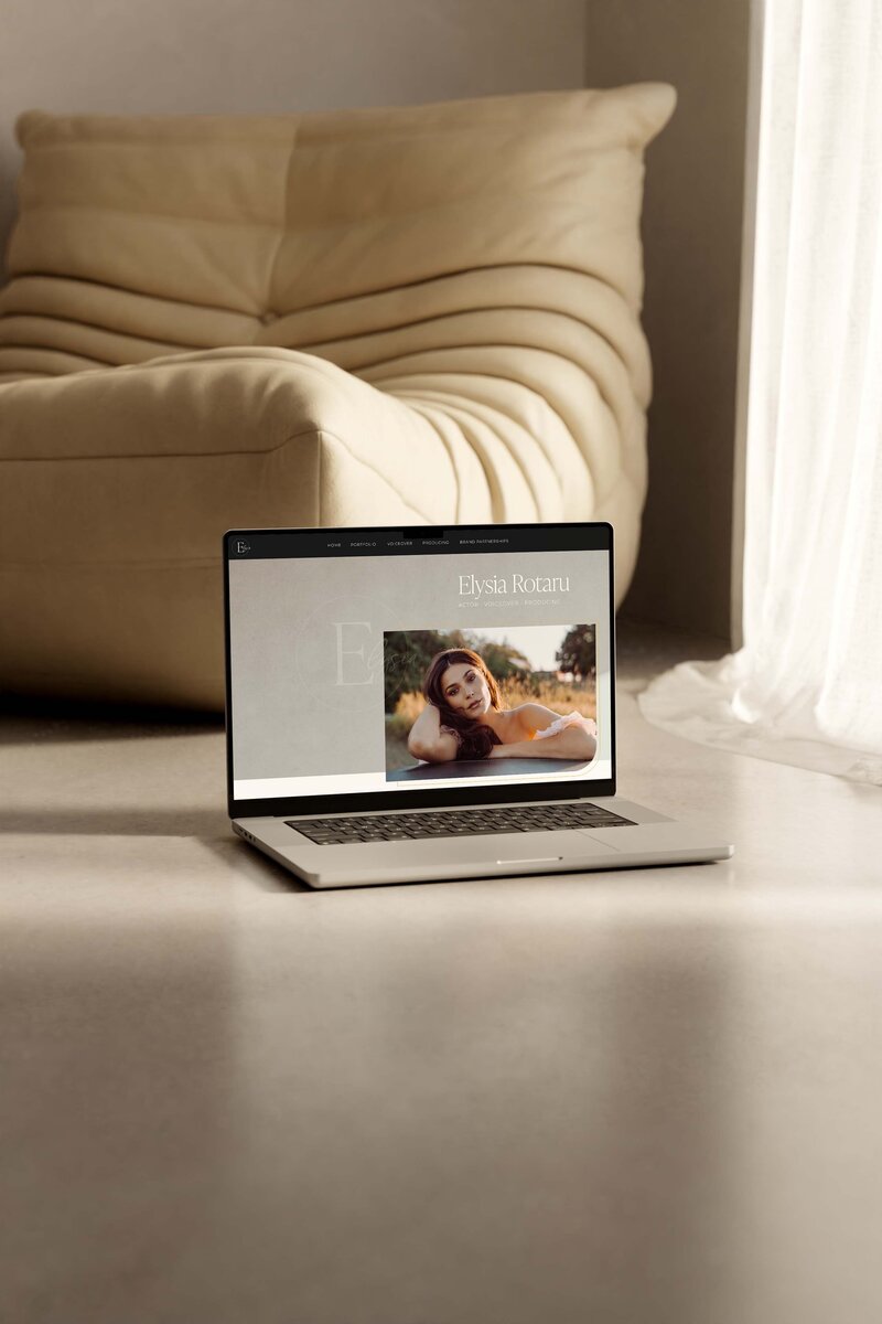 MacBook with open website in browser on the ground