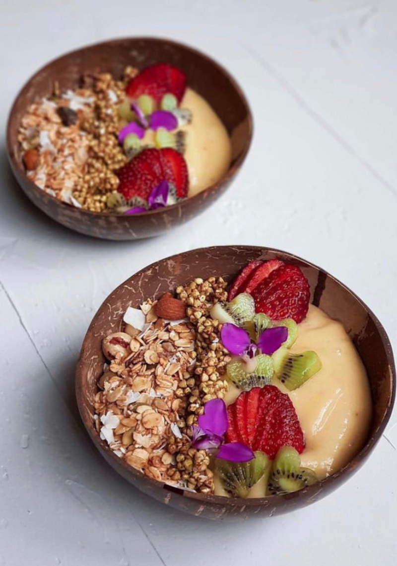 A mango smoothie bowl with kiri, strawberries and granola