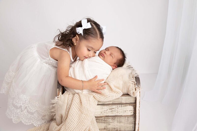 sweet and tender newborn sibling portraits, capturing the love and excitement of big brothers and sisters welcoming their baby.