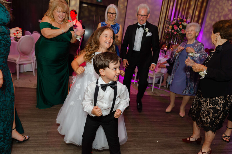 Ottawa wedding photography showing  a ring boy and flower girl dancing at Chateau Le Parc