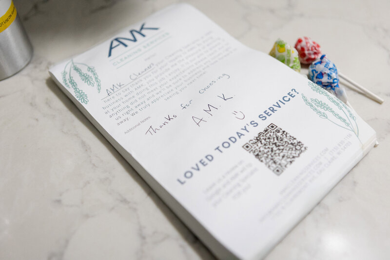 Note pad with logo of AMK Cleaning Services and a message from the cleaning crew.