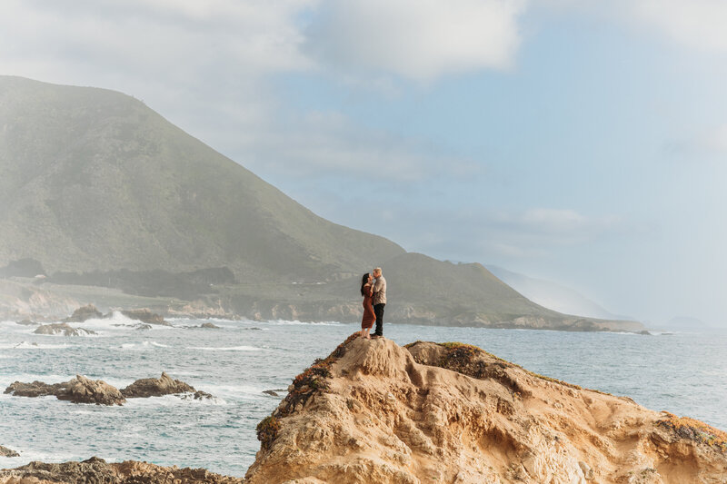 couple hugging in front of oceanscape