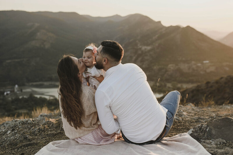 Woodlands Texas family kissing their baby