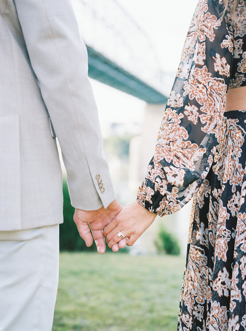 A couple holds hands at Coolidge Park by Northeast Alabama wedding photographer Kelsey Dawn Photography