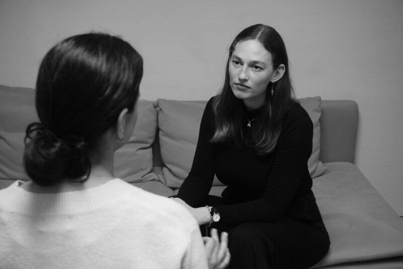 Cora Demary in conversation with a small group