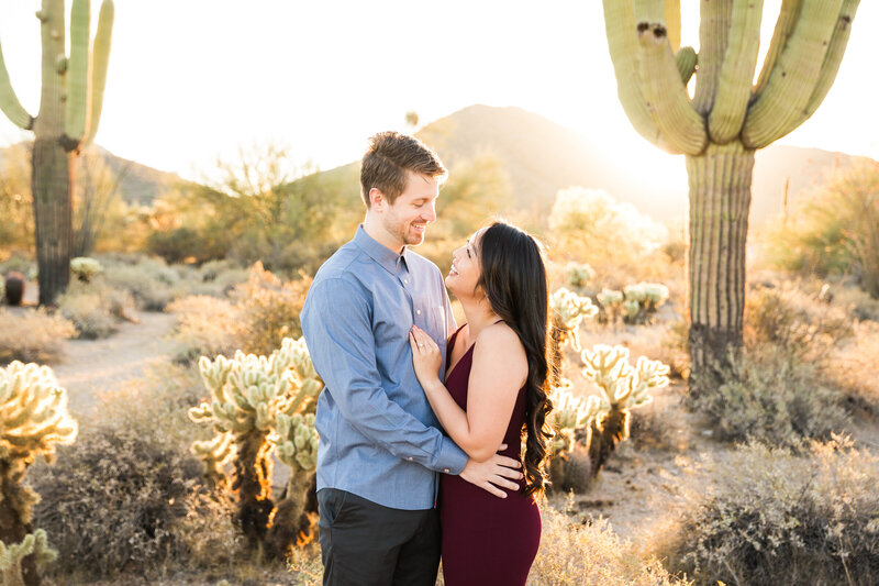 engaged couple smiling at each other in the Scottsdale desert
