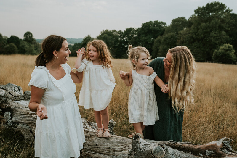 mothers and daughters with toddlers posing for outside portraits