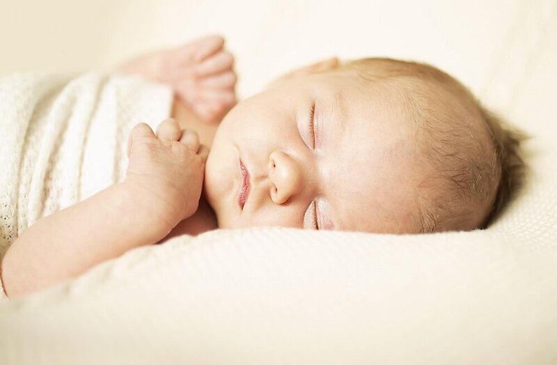 Newborn is fast asleep in their Dothan in-home session