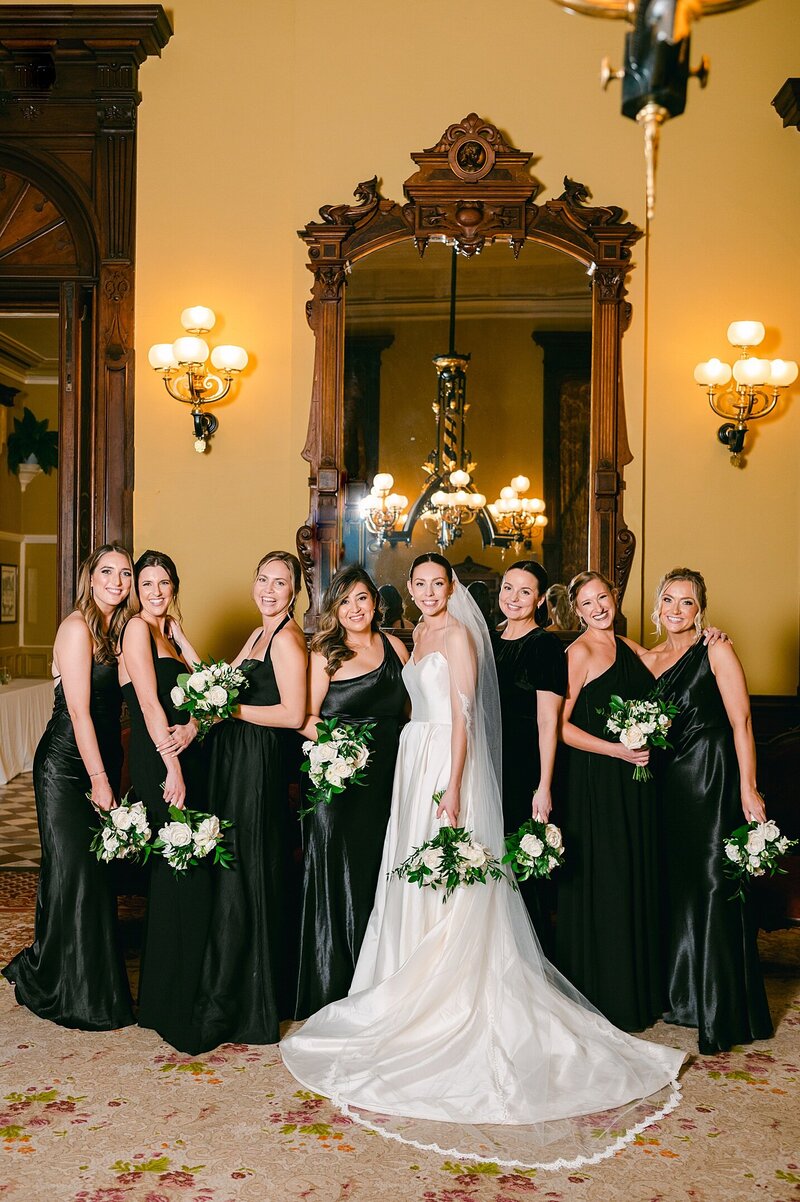 canfield casino wedding on new years with black satin dress and white flowers