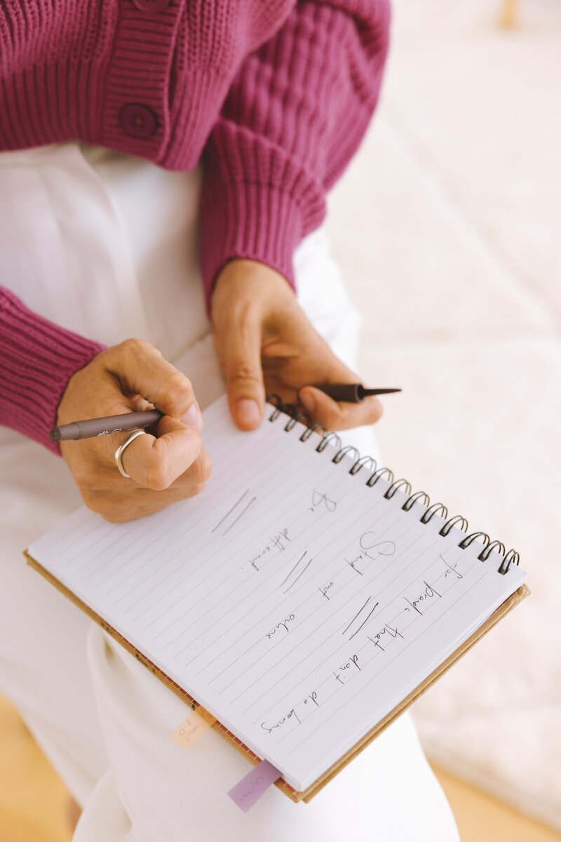 marisa writing website copy template in her notebook