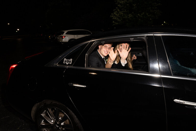 Spring wedding at WinMock at Kinderton, designed by Charming Carolina — bride and groom waving to guests from their classic getaway car before driving off.