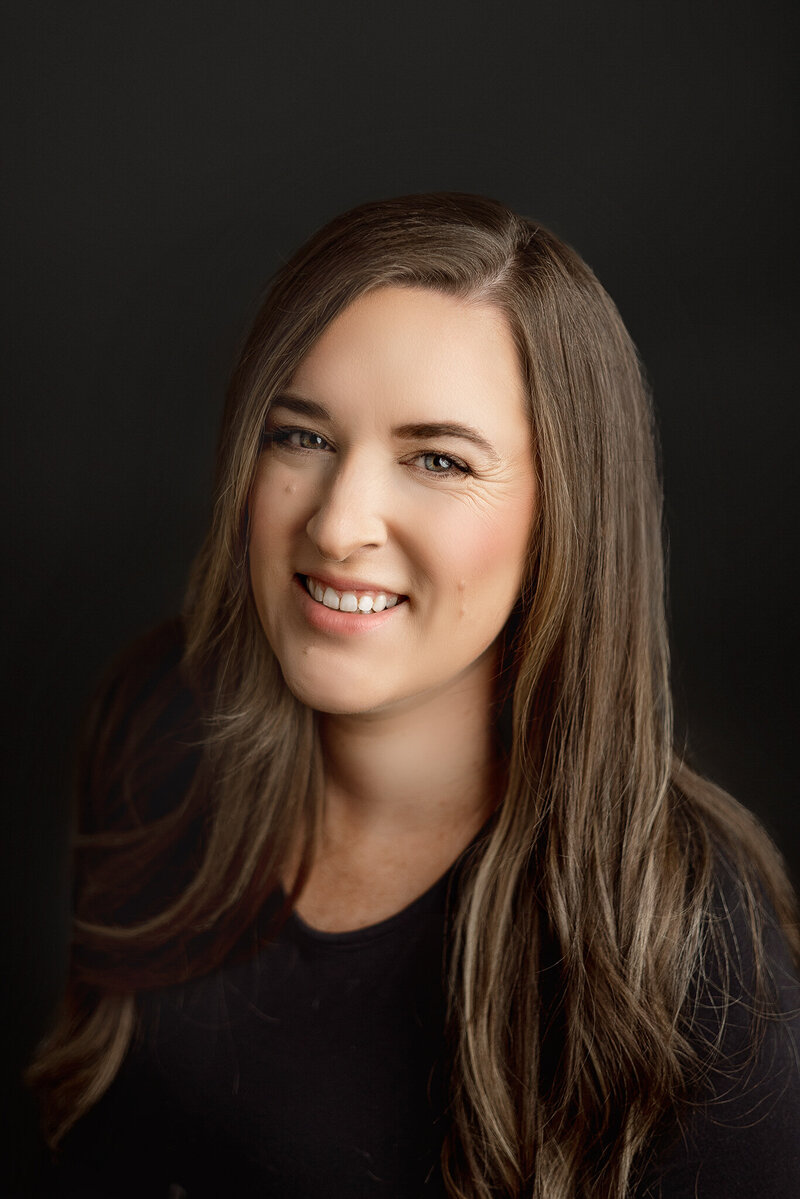 Professional portrait of Honeywild Photography owner, a newborn photographer based in Grand Rapids, Michigan, specializing in capturing timeless moments for families and babies
