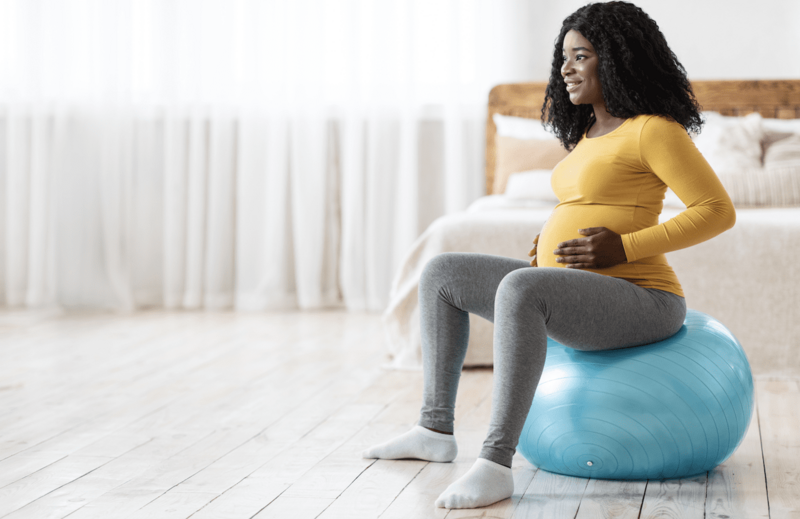 pregnant  mother holding hands over baby bump