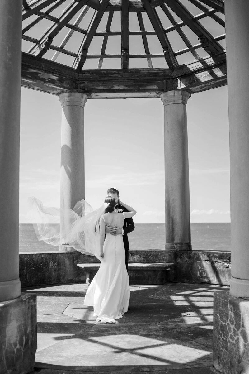 Bride and groom under pergola, veil blowing in wind, Cleveland Wedding, Renee Lemaire Photography