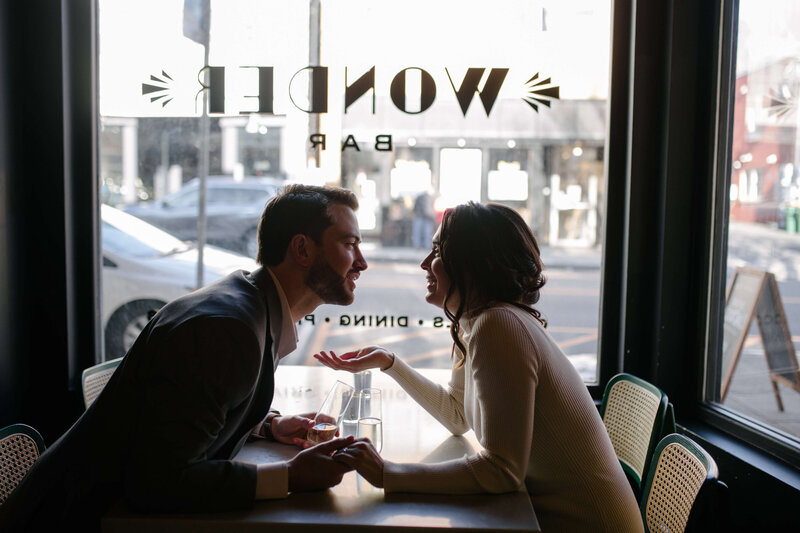 Couple getting drinks during their engagement session at Wonder Bar in Beacon, NY