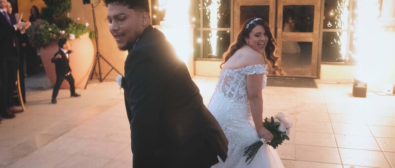 White bride and Hispanic groom making a grand entrance at The Retreat by Wedgewood Weddings in Corona, California.