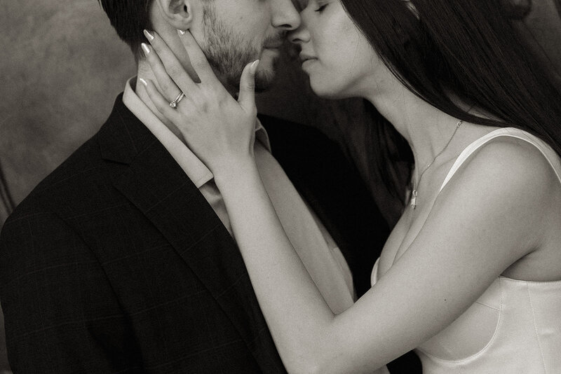a close up of a bride and groom about to kiss with her hand on his cheek in downtown winston salem.