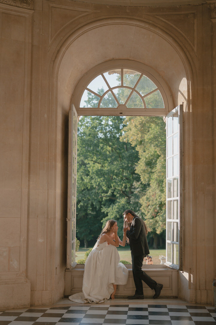 bride and groom in french chateau window