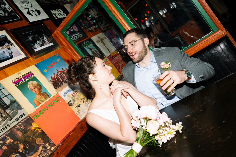 City elopement of fun couple gazing at eachother at restaurant after getting married