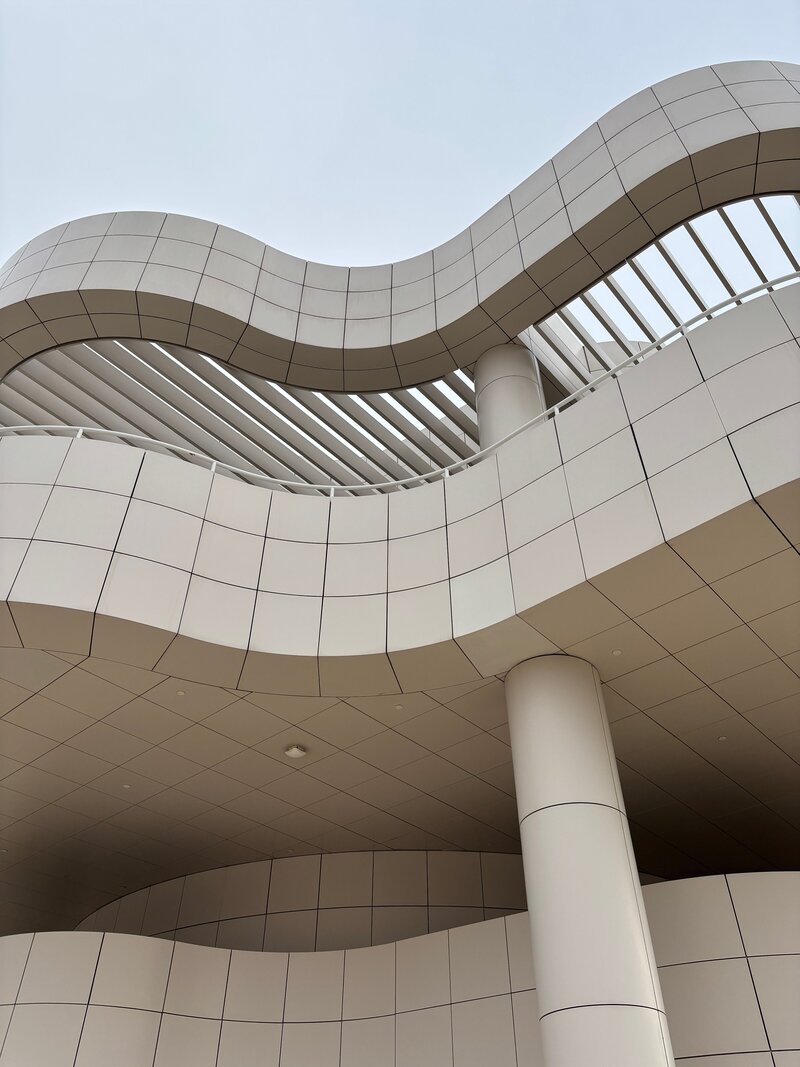Four Pierce PR team members collaborate at a table, smiling and discussing a project on a laptop.