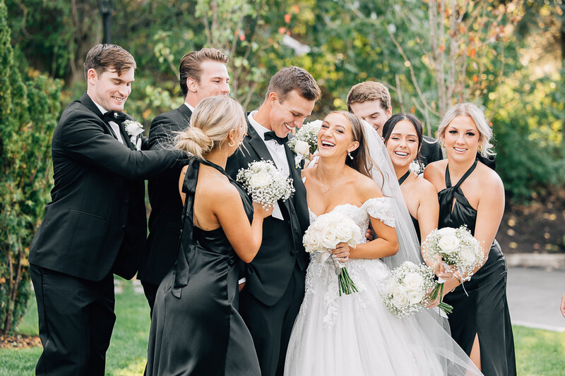 Beautiful bride and groom outside the Ogden, Utah Temple before their wedding with a colorful bouquet made by Bushel and a Peck Floral Design