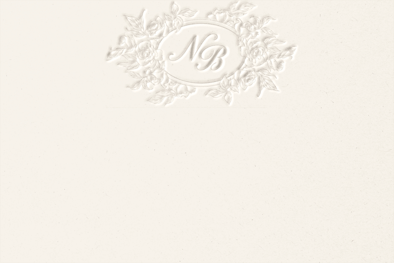 A beige notecard with a floral embossed logo of N B.