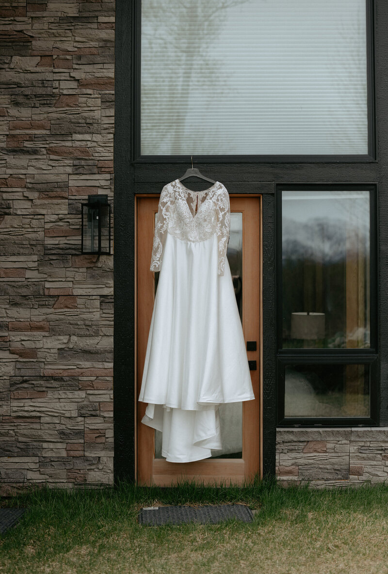 A dress hanging from a doorframe of an airbnb.