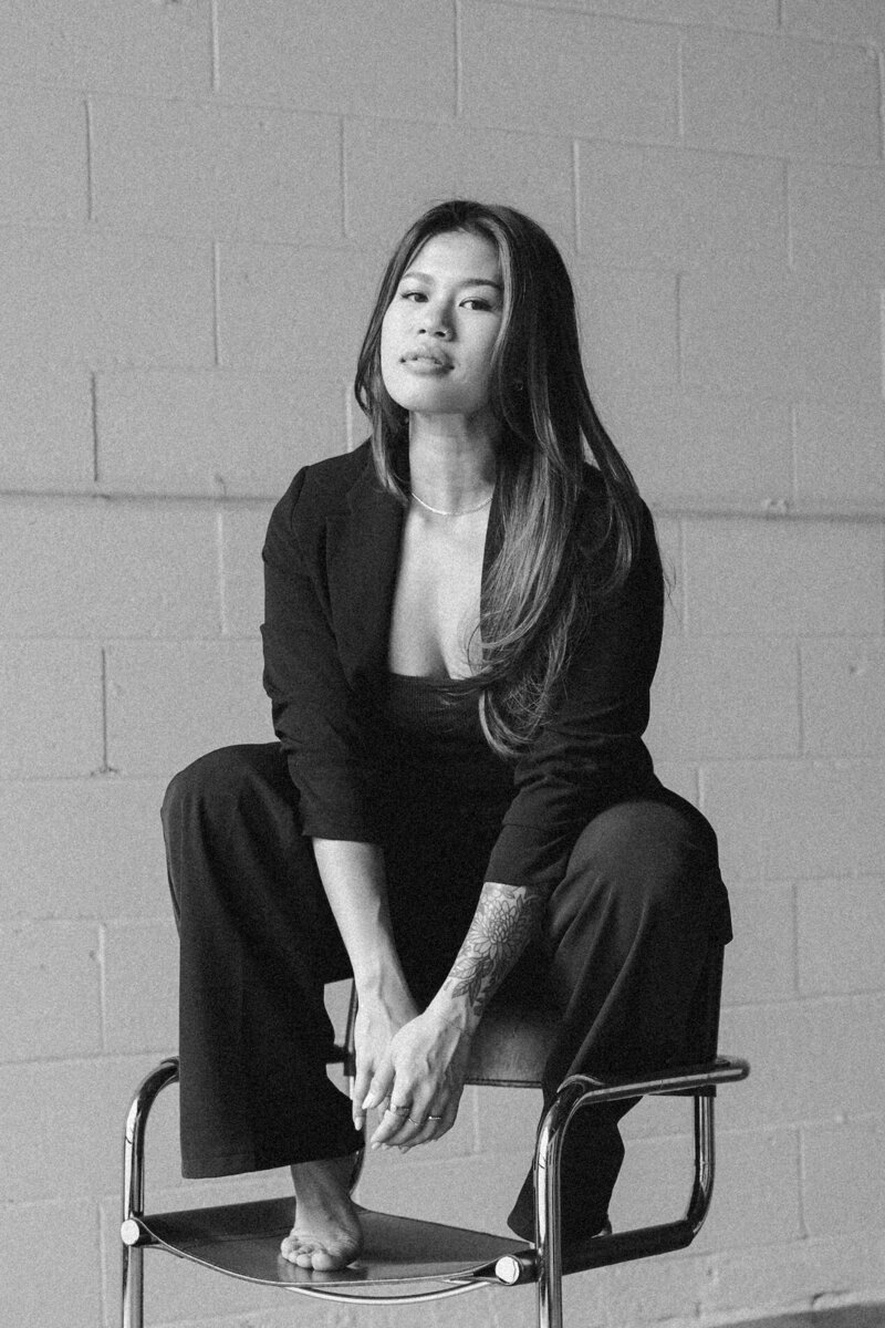susan ly sitting on chair