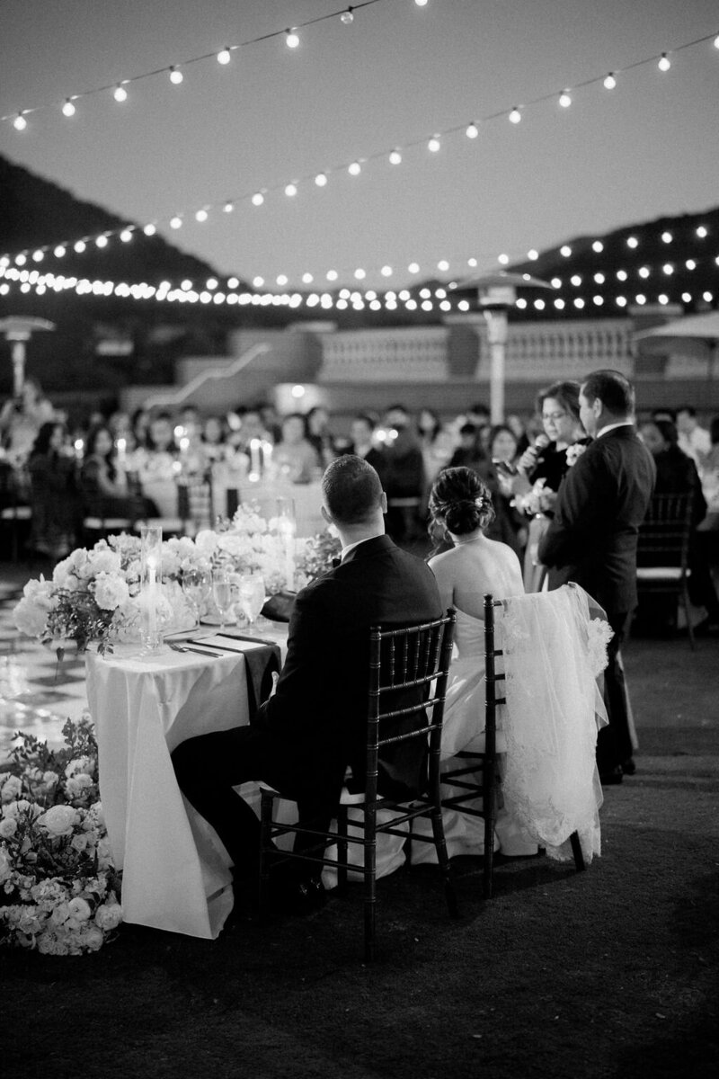 13-radiant-love-event-2021-outdoor-reception-bride-groom-dancing-guests-standing-around-white-dance-floor-black-white-romantic-elegant-timeless