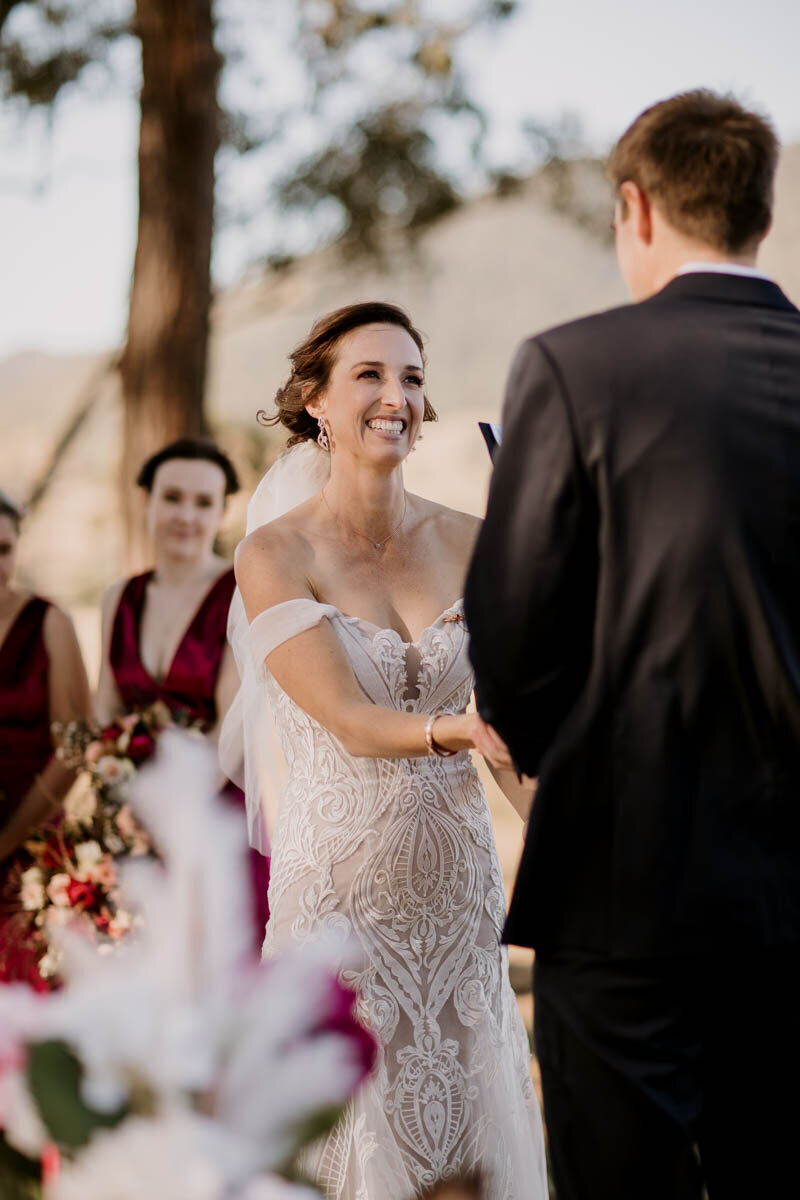 Happy bride smiling at the groom