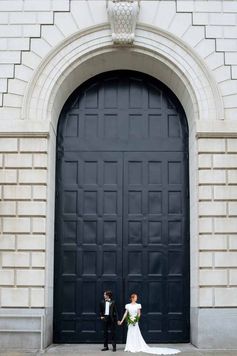 Tiffany Longeway Photography captures a stunning wedding portrait of the bride and groom against the grand architecture of San Francisco City Hall. The iconic and impressive design of the venue provides a dramatic and elegant backdrop, perfect for couples seeking a memorable and sophisticated setting for their wedding celebration.