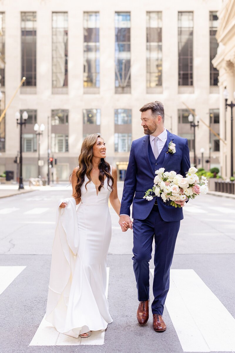 chicago wedding couple walks in front of the board of trade