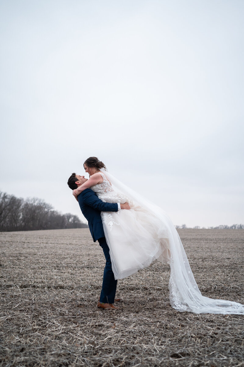 Groom embraces his bride forehead to forehead on their wedding day