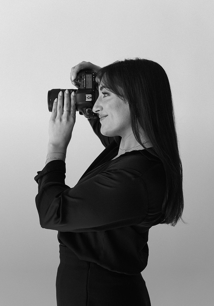 Dani Antony posing with a camera 