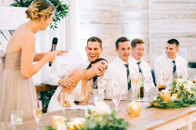bride and groom laughing during wedding toast at reception by winx photo tennessee wedding photographer