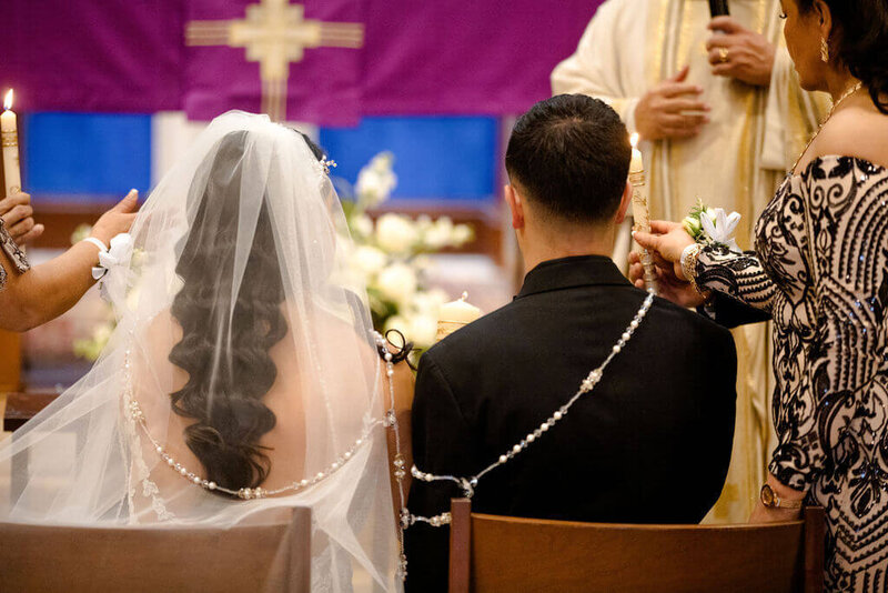 Latin couple with their symbolic rope at catholic wedding ceremony